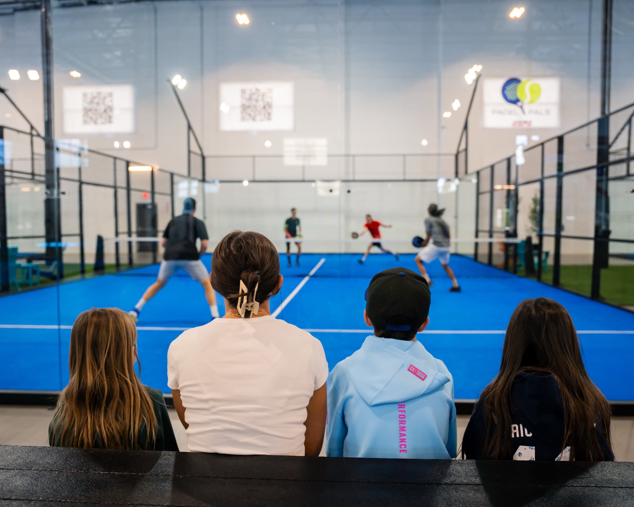 Guests watching an indoor padel match at Padel Pals